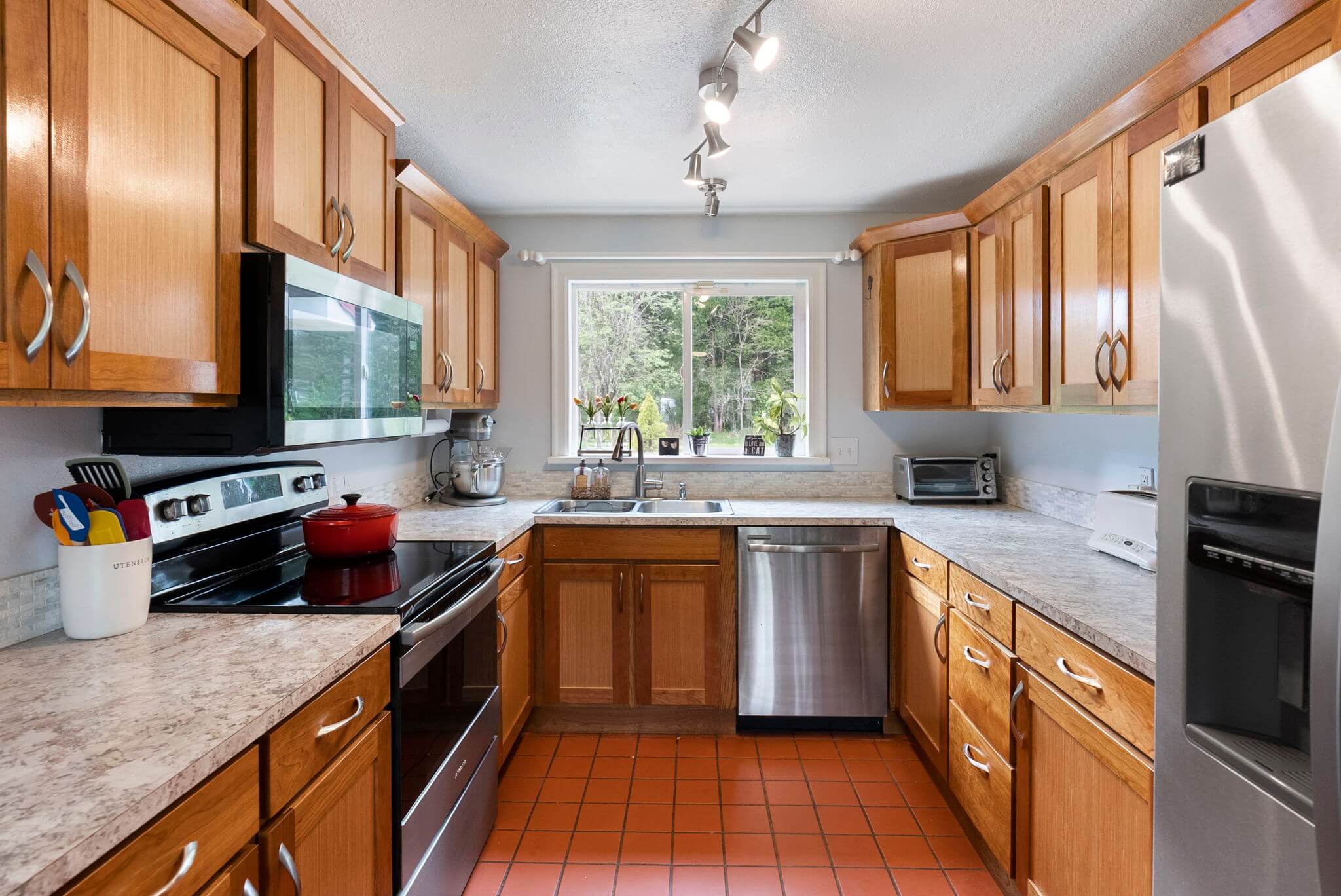 Updated kitchen with cherry cabinets and stainless appliances