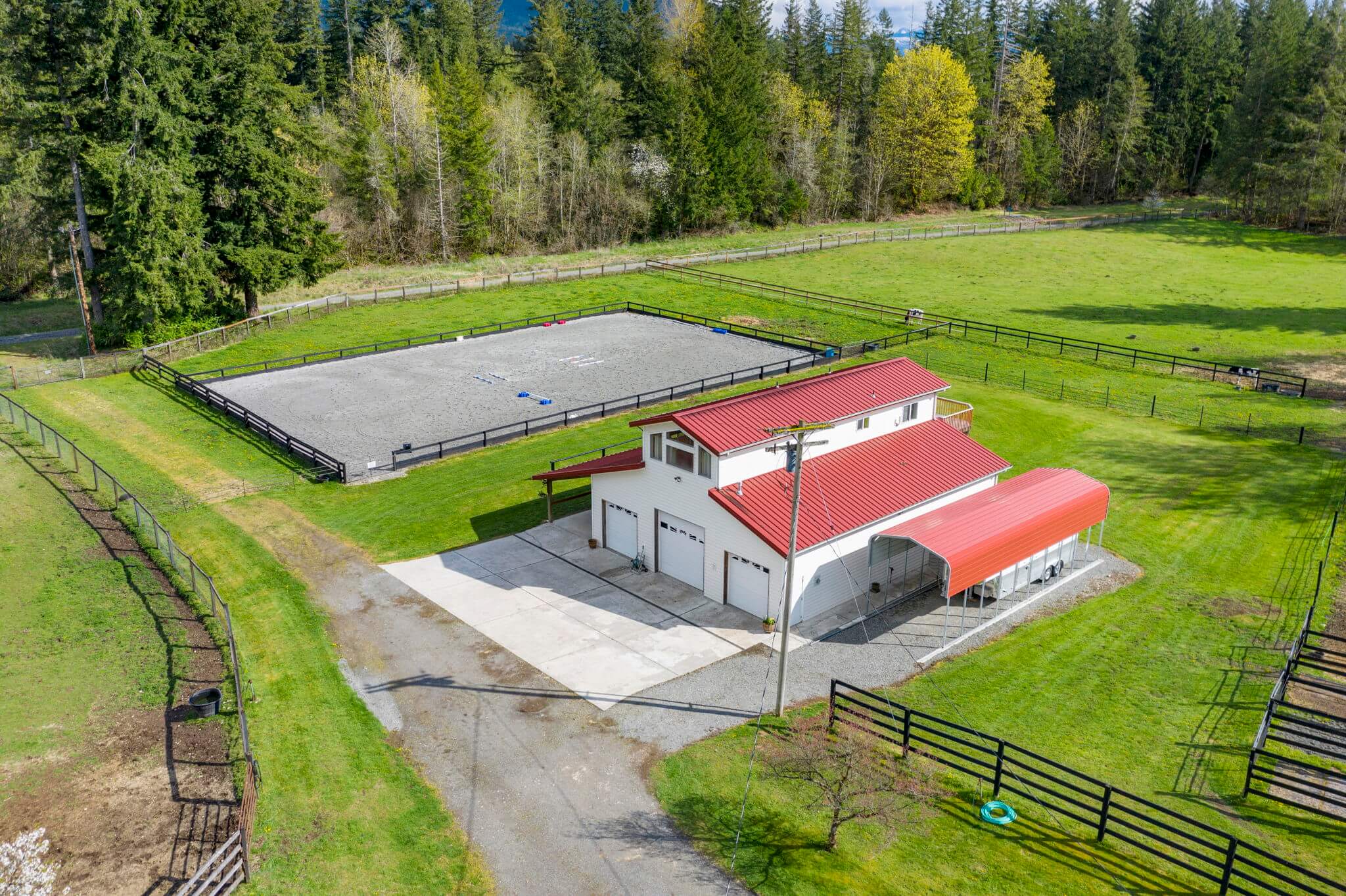 Outdoor arena and 48' x 50' barn with covered RV parking pad