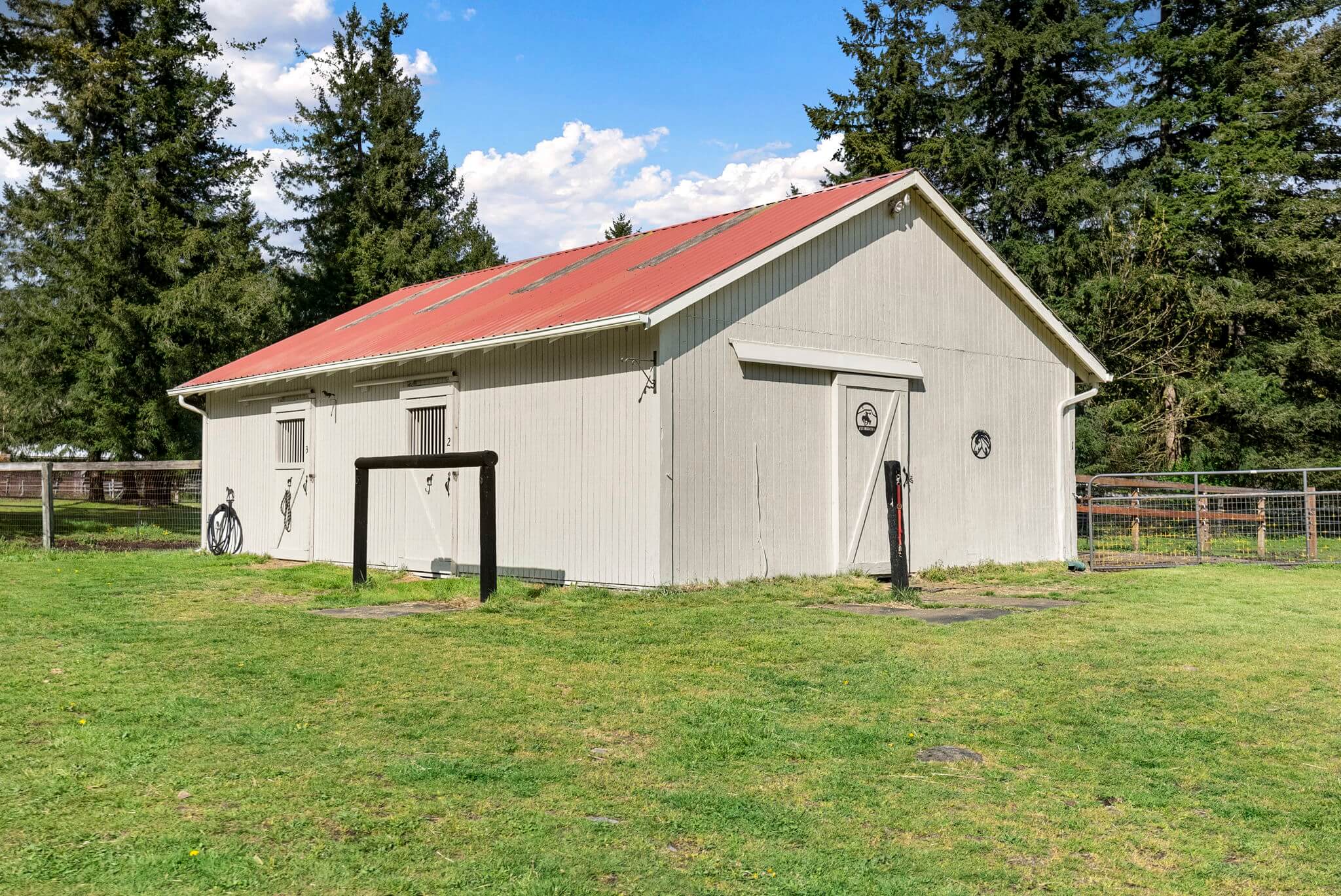 One of three smaller barns with a feed/tack room and three stalls with separate paddocks