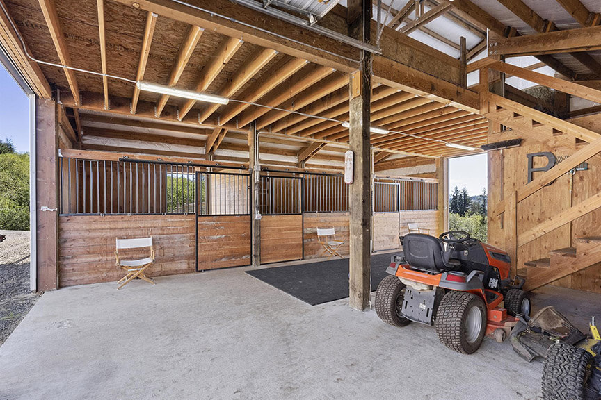 Barn includes three 12' x 12' rubber matted stalls, hot water and a 12-ton hay loft