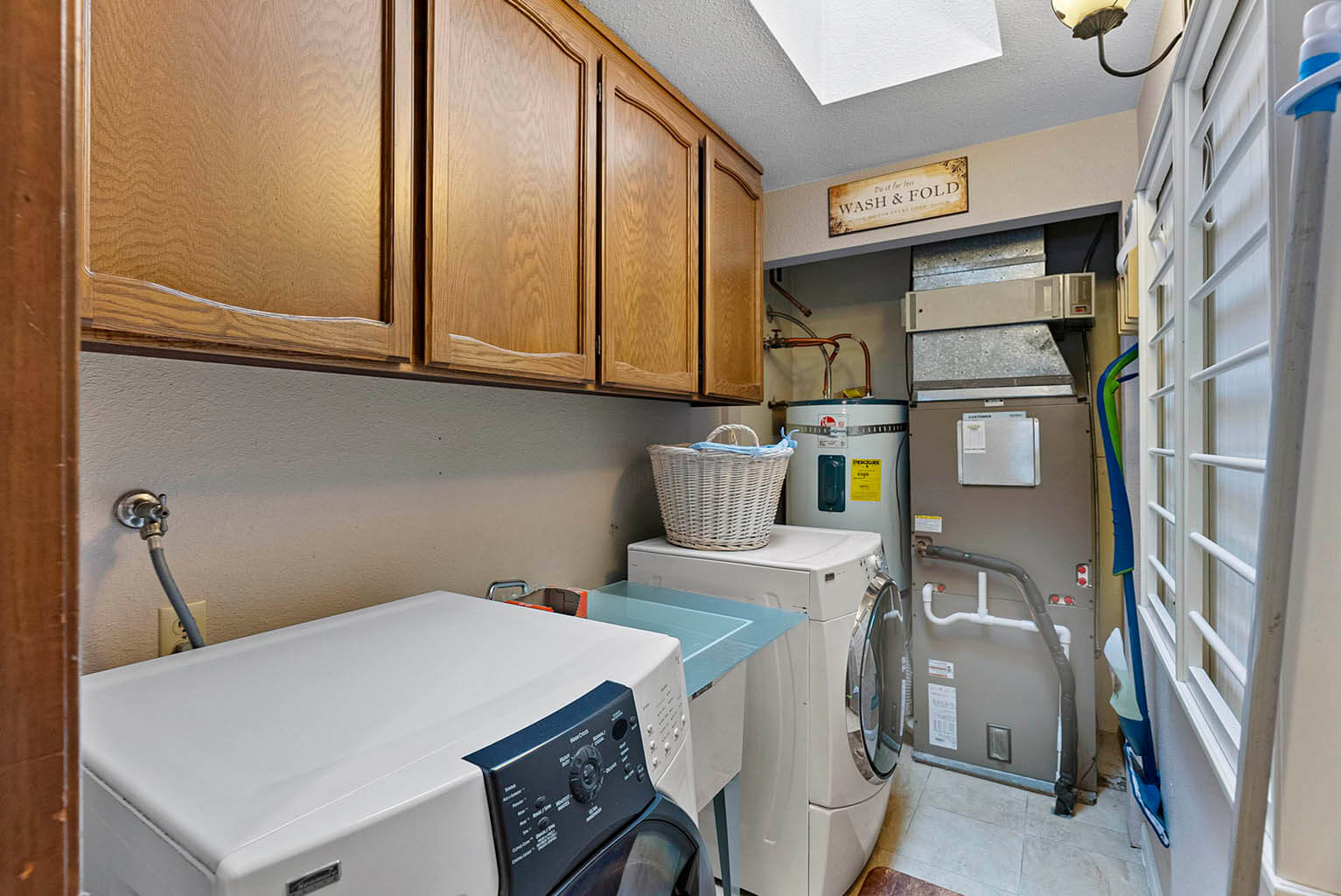 Laundry room with utility sink and cabinet storage