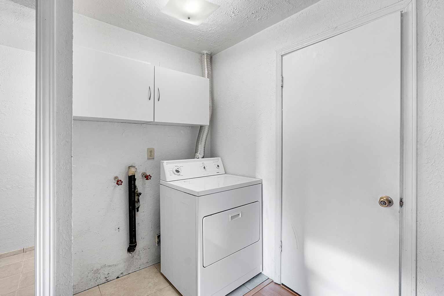 Caretaker’s apartment has a dedicated laundry area